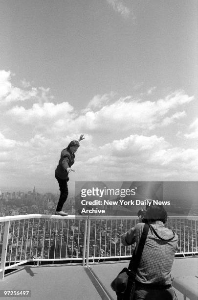 High-wire artist Philippe Petit shows catlike balance at edge of World Trade Center roof.