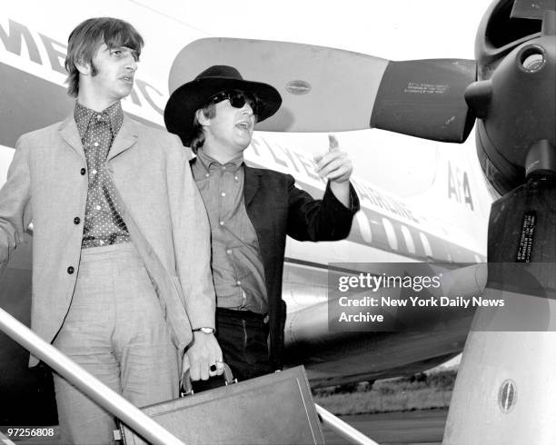 Beatles, Ringo Starr and John Lennon leave plane