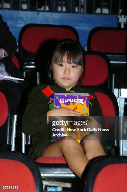 Bechet Dumaine Allen, the daughter of Woody and Soon-Yi Allen, holds tight to her box of popcorn at the Big Apple Circus' opening night gala benefit...