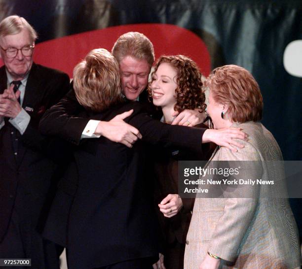 Hillary Rodham Clinton gets a hug from President Bill Clinton and daughter Chelsea after she officially launched her run for the Senate at SUNY...
