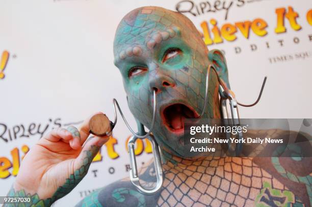 Erik Sprague twists a corkscrew through his nose and out through his mouth during the opening celebration of the new Ripley's Believe It or Not...