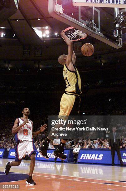 Indiana Pacers' Reggie Miller dunks as New York Knicks' Latrell Sprewell watches in Game 6 of the Eastern Conference finals at Madison Square Garden.