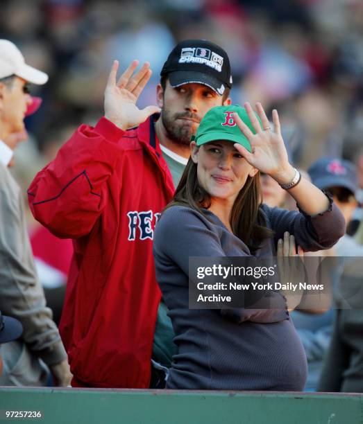 Ben Affleck and wife Jennifer Garner, who's expecting their first child, wave as they take in a game between the Boston Red Sox and the New York...