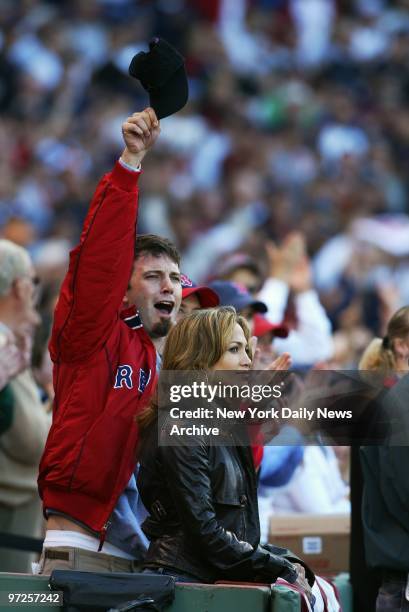 Ben Affleck cheers for the Boston Red Sox but girlfriend Jennifer Lopez seems less impressed during Game 3 of the American League Championship Series...