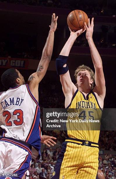 Indiana Pacers' Rik Smits shoots over New York Knicks' Marcus Camby in the Eastern Conference finals at Madison Square Garden.