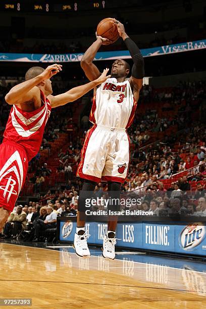 Dwyane Wade of the Miami Heat shoots a jump shot against Shane Battier of the Houston Rockets during the game at American Airlines Arena on February...