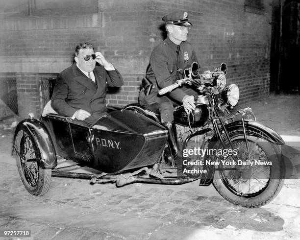 Let's go, says Mayor Fiorello LaGuardia as he jumps into motorcycle cop Joseph W. Lamb's sidecar and prepares for a lickety-split ride from Summer...