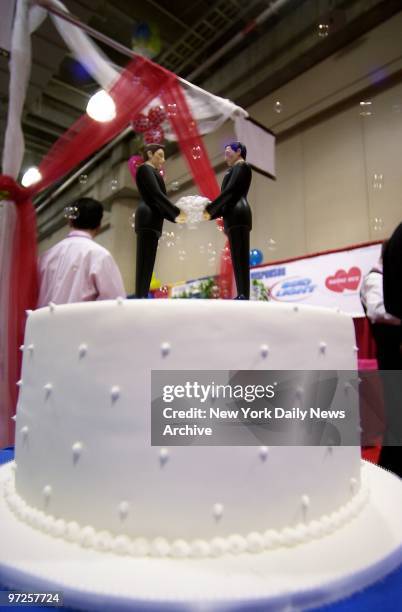 His 'n' his wedding cake toppers from The Knot are on display during the Same Sex Wedding Expo at the Javits Convention Center. Offering everything...