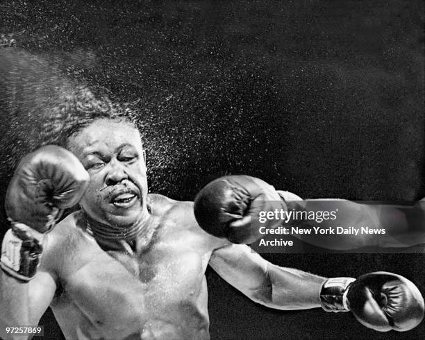 Kid Gavilan absorbs a hair-raising right to the jaw delivered by Sugar Ray Robinson at bout in Philadelphia's Municipal Stadium. Robinson took a...