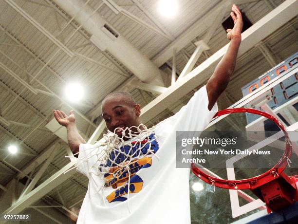 Hofstra guard Craig Claxton cuts down the net after his team knocked off Delaware, 76-69, in the finals of the America East conference tournament at...