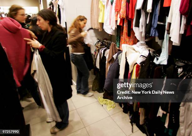 Holiday shoppers look through clothing racks at the H&M store on W. 34th St.