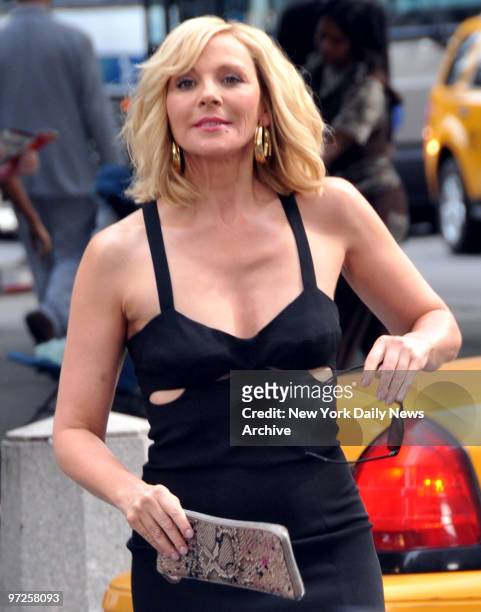 Kim Cattrall in this scene runs across 58th Street and almost is hit by a auto as they film Sex And The City outside of Bergdorf Goodman.,