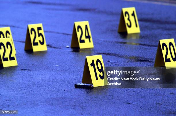 Evidence markers dot the street after a wild shootout on New Lots Ave. Off Ashford St. In East New York, Brooklyn. Cops from the 75th Precinct...