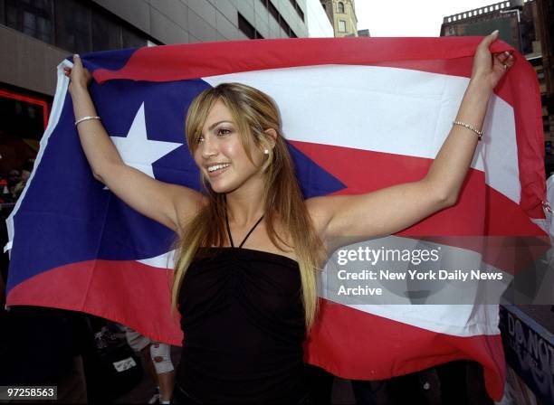 Jennifer Lopez carries the Puerto Rican flag as she arrives at the Virgin Megastore at 14th St. And Broadway to autograph her CD "On the 6."