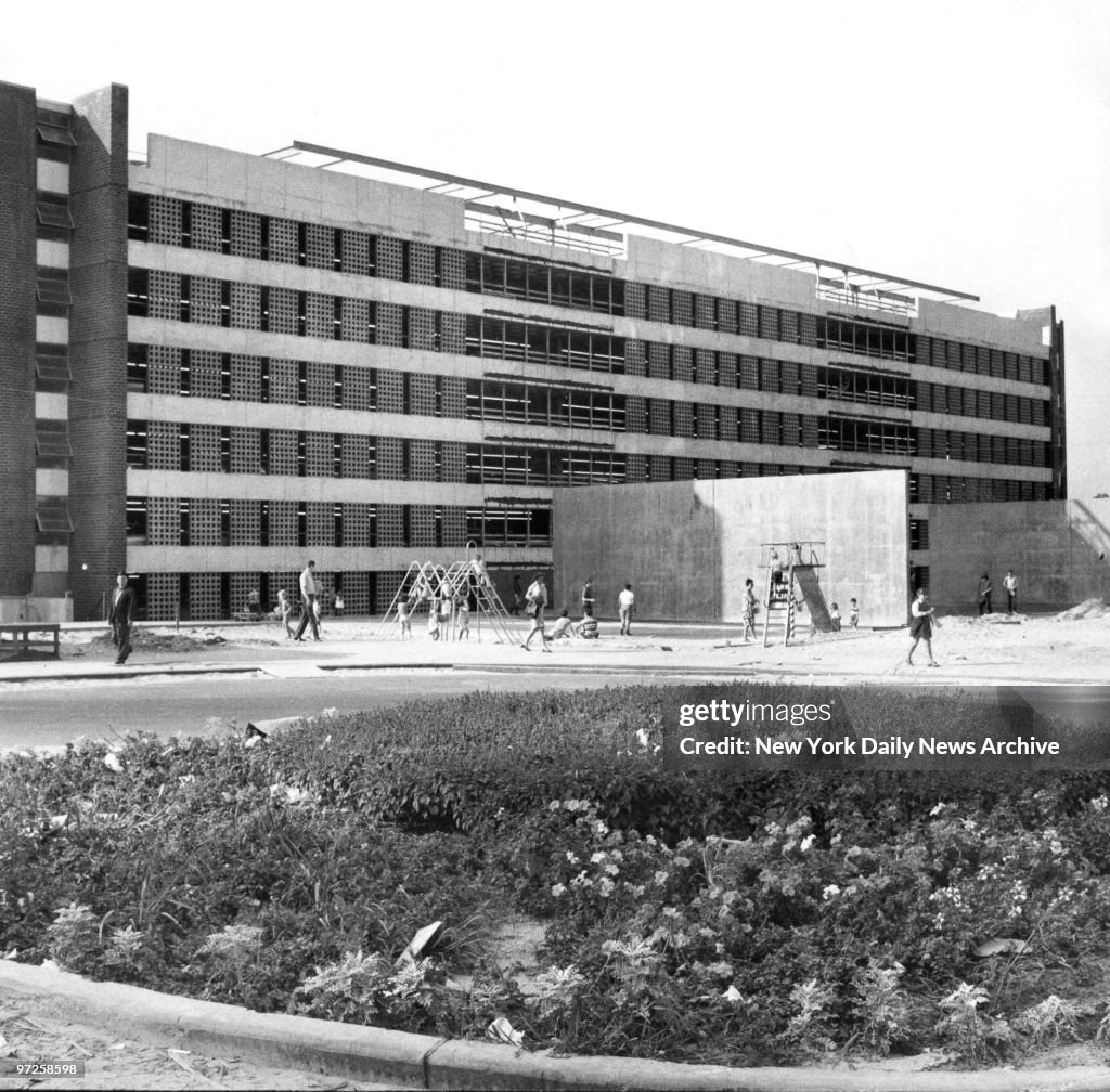 Kids play in front of Co-op City building at Darrow Place