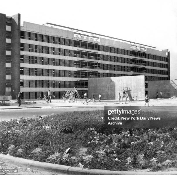 Kids play in front of Co-op City building at Darrow Place