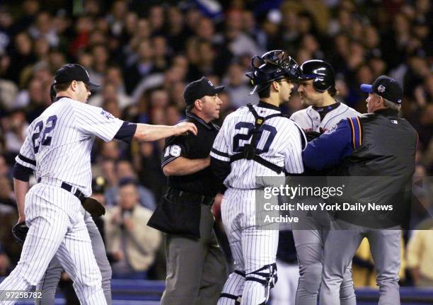 Home plate umpire Charlie Reliford steps between New York Mets' Mike Piazza and New York Yankees' starting pitcher Roger Clemens as they argue after...