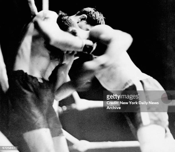 Christopher Battalino holds Billy Petrolle against the ropes as he punches away at his stomach at Queensboro Stadium.