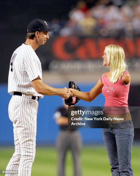 Bethany Hamilton shakes hands with New York Yankees' pitcher Randy Johnson after she threw out the ceremonial first pitch before the start of a game...