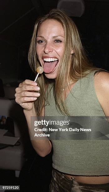 Kimmi Kappenberg of "Survivor: the Australian Outback" samples a lollipop at an auction-benefit for Animal Avengers at Spa on E. 13th St. The...