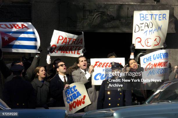 Extras playing demonstrators wave signs reading "Better Dead Than Red" and "Free Cuba Now!" at Second Ave. And E. 42nd St. During the filming of...