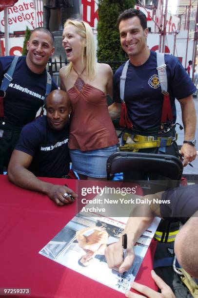 Christy Denison, from Dallas, Tex., has her picture taken with Firefighters Justin Zuckerman, Sheldon George, and Steve Barretta as Firefighter Phil...