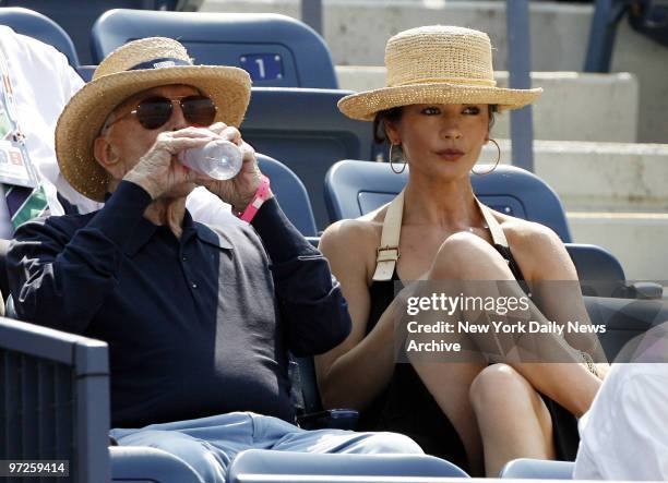 Kirk Douglas and Catherine Zeta Jones watch David Ferrer of Spain take on Novak Djokovic of Serbia during their semi-final match at the U.S. Open.