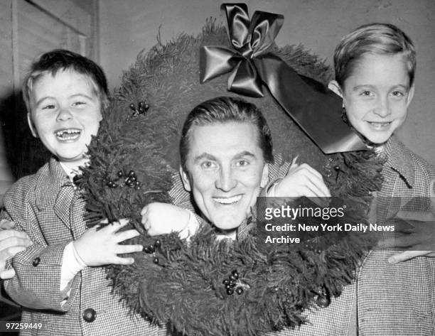 Kirk Douglas with sons, Joel and Michael, at Idlewild Airport.