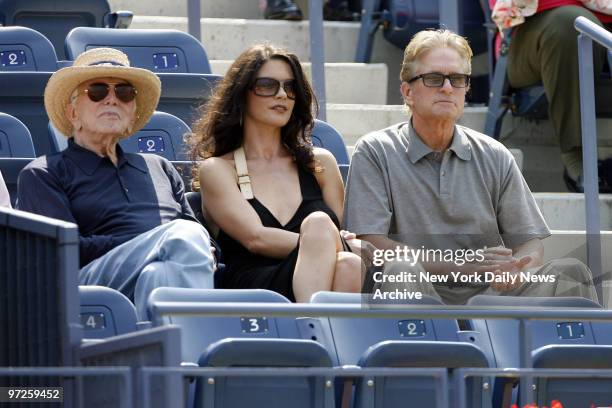 Kirk Douglas, Catherine Zeta Jones and Michael Douglas watch David Ferrer of Spain take on Novak Djokovic of Serbia during their Men's Semi-Finals of...