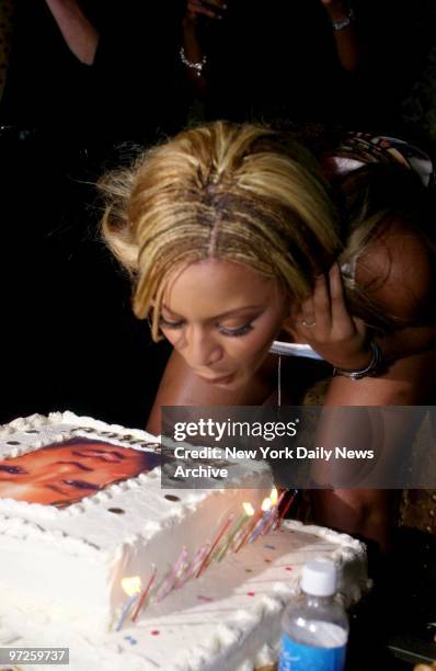 Beyonce Knowles of Destiny's Child blows out the candles on her cake during a surprise birthday party thrown for her by MTV at Club One51 in...