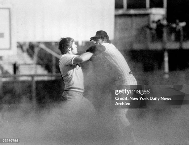 Cincinnati Reds' Pete Rose is tagged out at second base, on front end of a double play, by New York Mets' Bud Harrelson. Rose started a fight with...