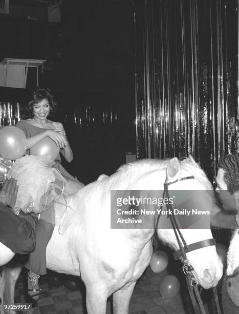 Bianca Jagger, the birthday girl, straddles an equine visitor to her birthday bash at Studio 54