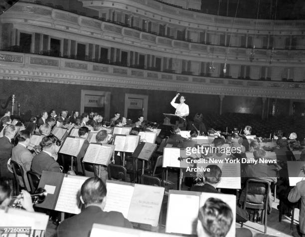 Leonard Bernstein, 25 years old, conducts a rehearsal for his first symphony "Jeremiah" with the Philharmonic Symphony Orchestra in Carnegie. It will...
