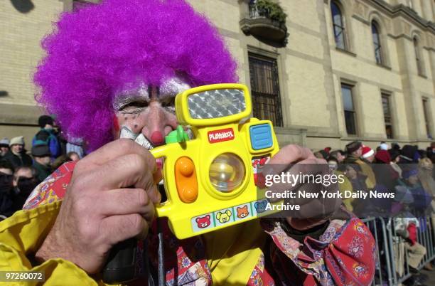Clifford the Clown uses a toy camera to snap shots of the crowd as he marches in the 76th annual Macy's Thanksgiving Day Parade. An estimated 2.5...