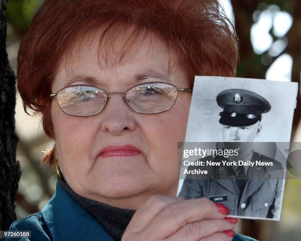 Lora Owens holds a photograph of her stepson, Albert Owens, in his U.S. Army uniform. Albert Owens was murdered by deathrow inmate Stanley Tookie...