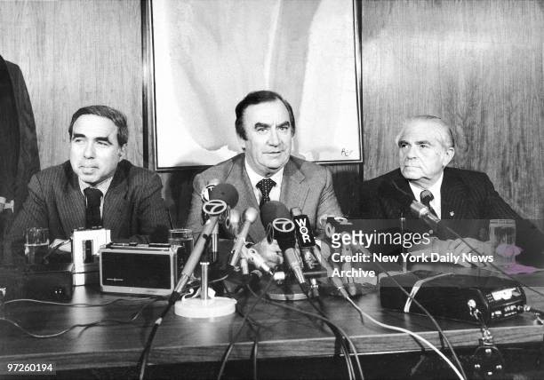Big M.A.C. Chairman Felix Rohatyn, Gov. Hugh Carey and Mayor Abe Beame at news conference in the Eastern Airlines Terminal of John F. Kennedy Airport...
