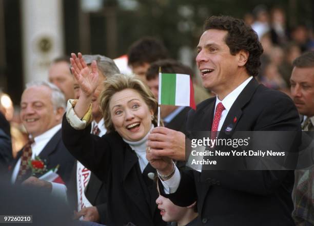 Housing and Urban Development Secretary Andrew Cuomo waves a small Italian flag and Senate candidate Hillary Rodhman Clinton waves to the crowd...