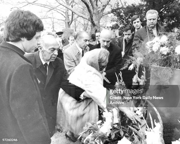 Loretta Costello, Frank Costello's widow places flower on the casket.
