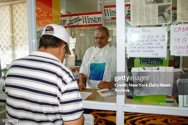 Ronaldo Martinez, who stars in a series of graphic anti-smoking television ads, stands in front of signs touting cigarettes as he works behind the...