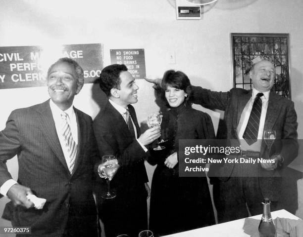 City Clerk David Dinkins, Juan Torres, his bride Minerva and Mayor Ed Koch share a toast and a laugh, as Mayor Koch points to "No Drinking" sign in...