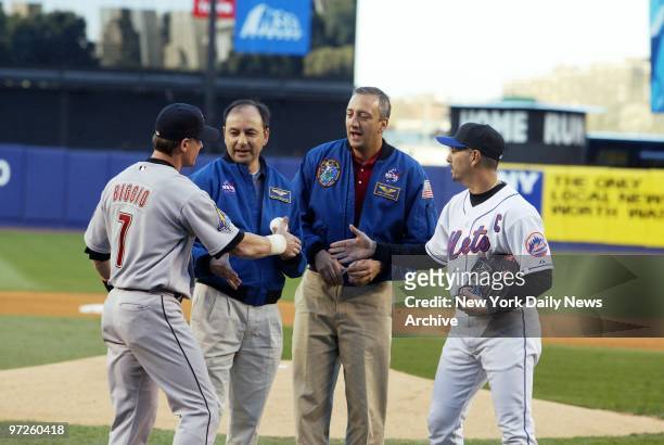 Houston Astros' outfielder Craig Biggio and New York Mets' pitcher Jon Franco greet NASA's Mark Polansky and Michael Massimino before the astronauts...