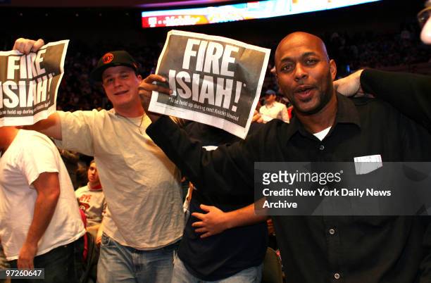 Knicks fan Victor Williams of Brooklyn holds a sign saying "Fire Isiah!" during the Knicks game against the Cleveland Cavaliers.
