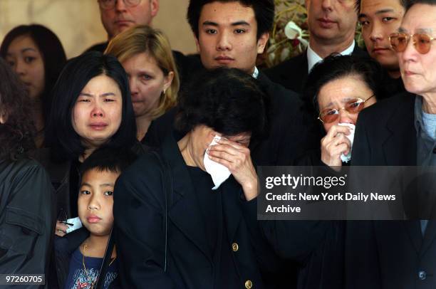 Family members weep during a traditional Buddhist funeral service for Stuyvesant High School freshman April Lao at the Chun Fook Funeral Home in...