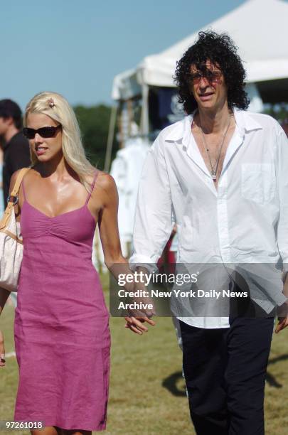 Howard Stern and girlfriend Beth Ostrosky walk hand-in-hand on the second weekend of the annual Mercedes-Benz Polo Challenge at the Bridgehampton...