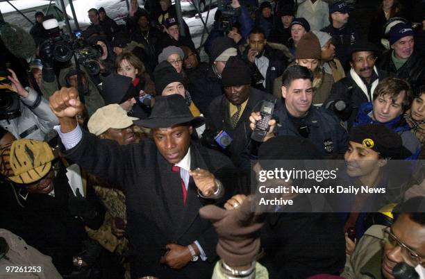 City Councilman Bill Perkins holds his fist in the air as he leads a rally at Manhattan Supreme Court in support of the five defendants in the...