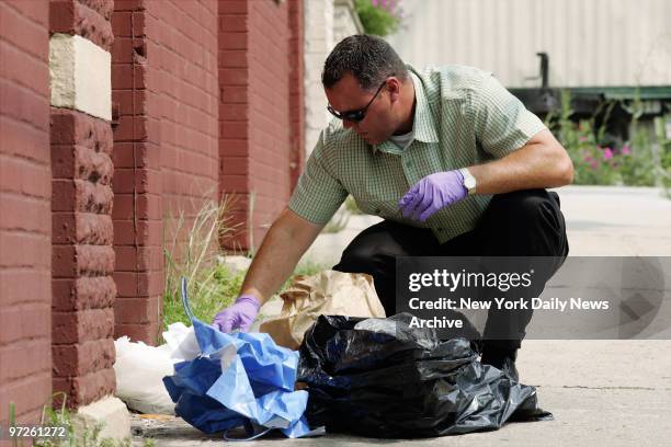 Hudson County Homicide Det. Tim Sullivan looks through garbage from the Park Ave. Hotel in Weehawken, N.J., where Jennifer Moore was last seen before...