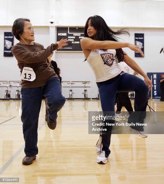Fanny Militar matches the moves of her granddaughter, New Jersey Nets Dancer Trixia Camacho, at the team's practice facility as the Nets hold...