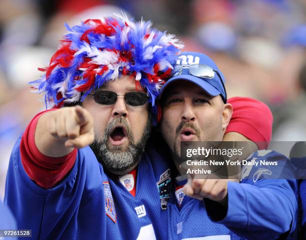 Fans at Giants Stadium see their team defeat Atlanta Falcons 34-31 yesterday in overtime to break 4-game losing streak.