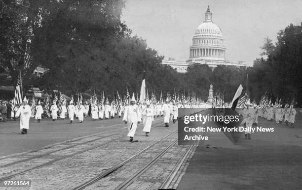 Ku Klux Klan members march in a parade down Pennsylvania Avenue from the capitol to the treasury in Washington D.C., 8th August 1925.