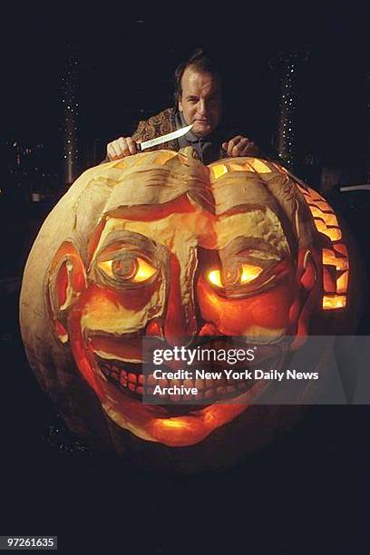 Hugh McMahon, in the Kit Kat Club, with 600 lb. Pumpkin in which he carved the Coney Island face.